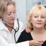 Female provider listening the heart of a female patient