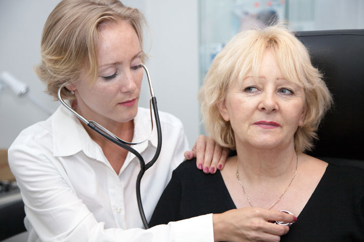 Female provider listening the heart of a female patient