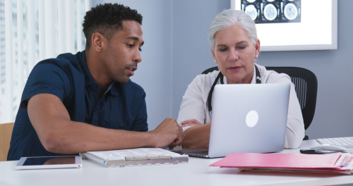 Portrait,Of,Doctor,And,Patient,Using,Notebook,Computer,Inside,Doctors