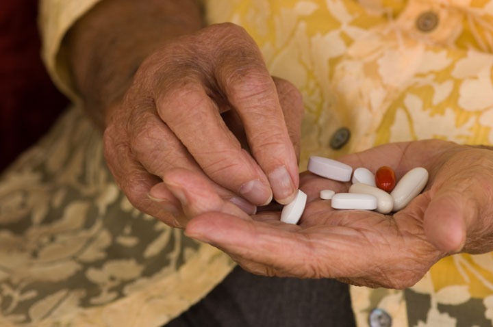 Older woman sorting medications