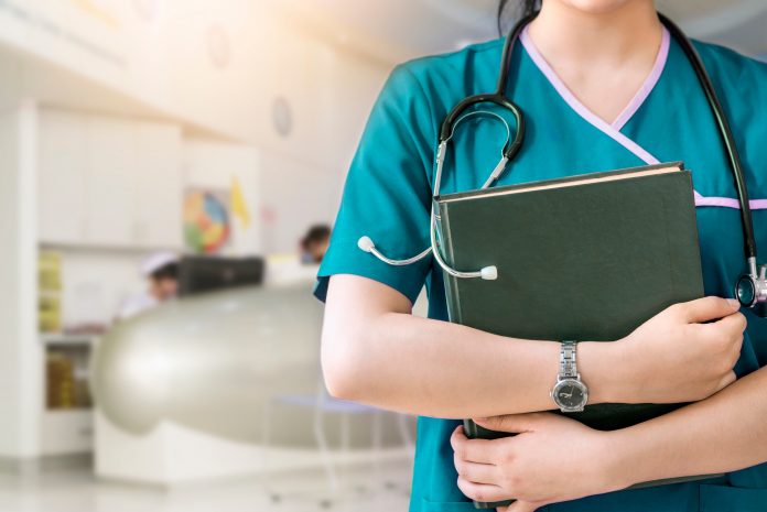 Cropped,Image,Of,Nurse,In,Purple,Uniform,Holding,Green,Book