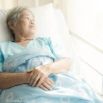 Older patient alone in hospital bed