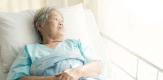 Older patient alone in hospital bed