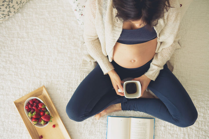 Pregnant woman with a cup of coffee