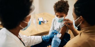 NP giving child a vaccine