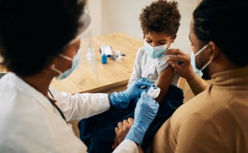 NP giving child a vaccine