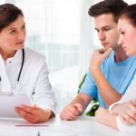 Couple discussing genetic screening results with NP