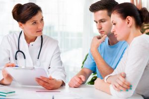 Couple discussing genetic screening results with NP