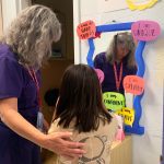 Nurse Practitioner and school nurse Jodi Bobbitt helps a youngster at William Ramsay Elementary in Alexandria, Virginia. (Colleen DeGuzman/KFF Health News)