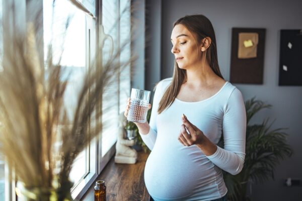 Pregnant woman and pill